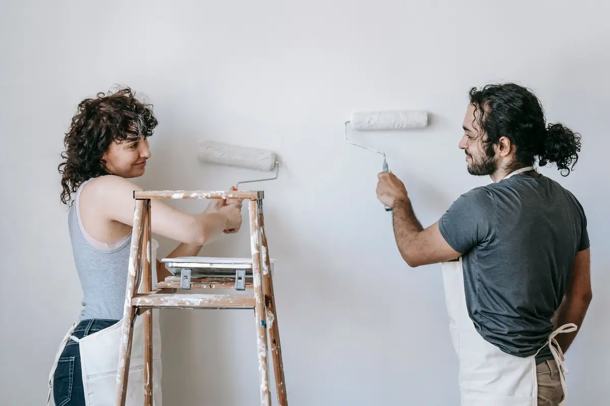 People painting a wall together — painting help in Jackson