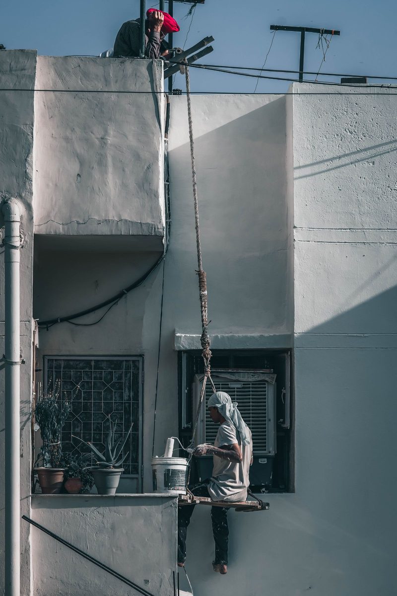 Worker on scaffolding at a building facade